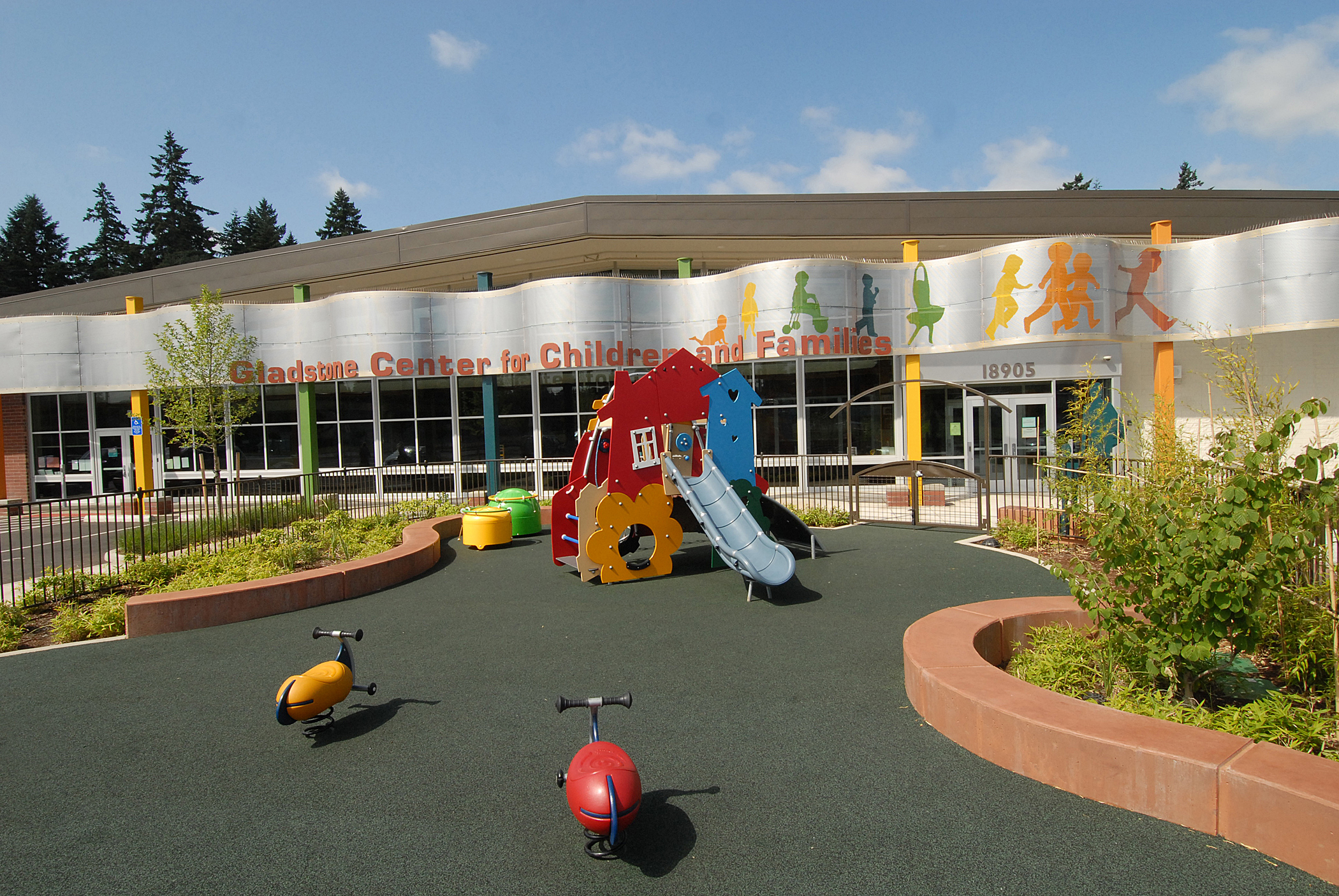 gladstone center for children and families building with slide and playground in foreground