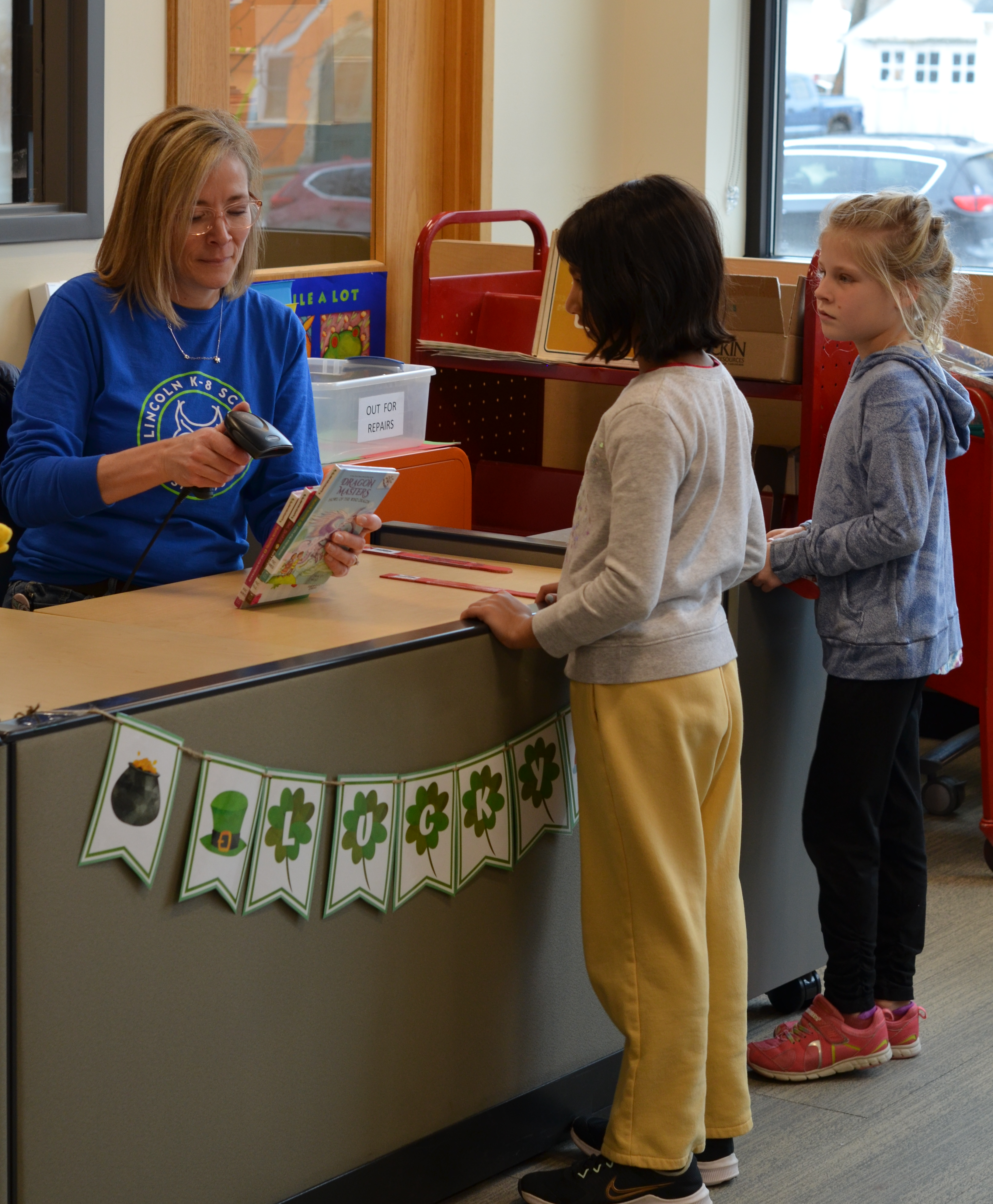 Students checking out library books