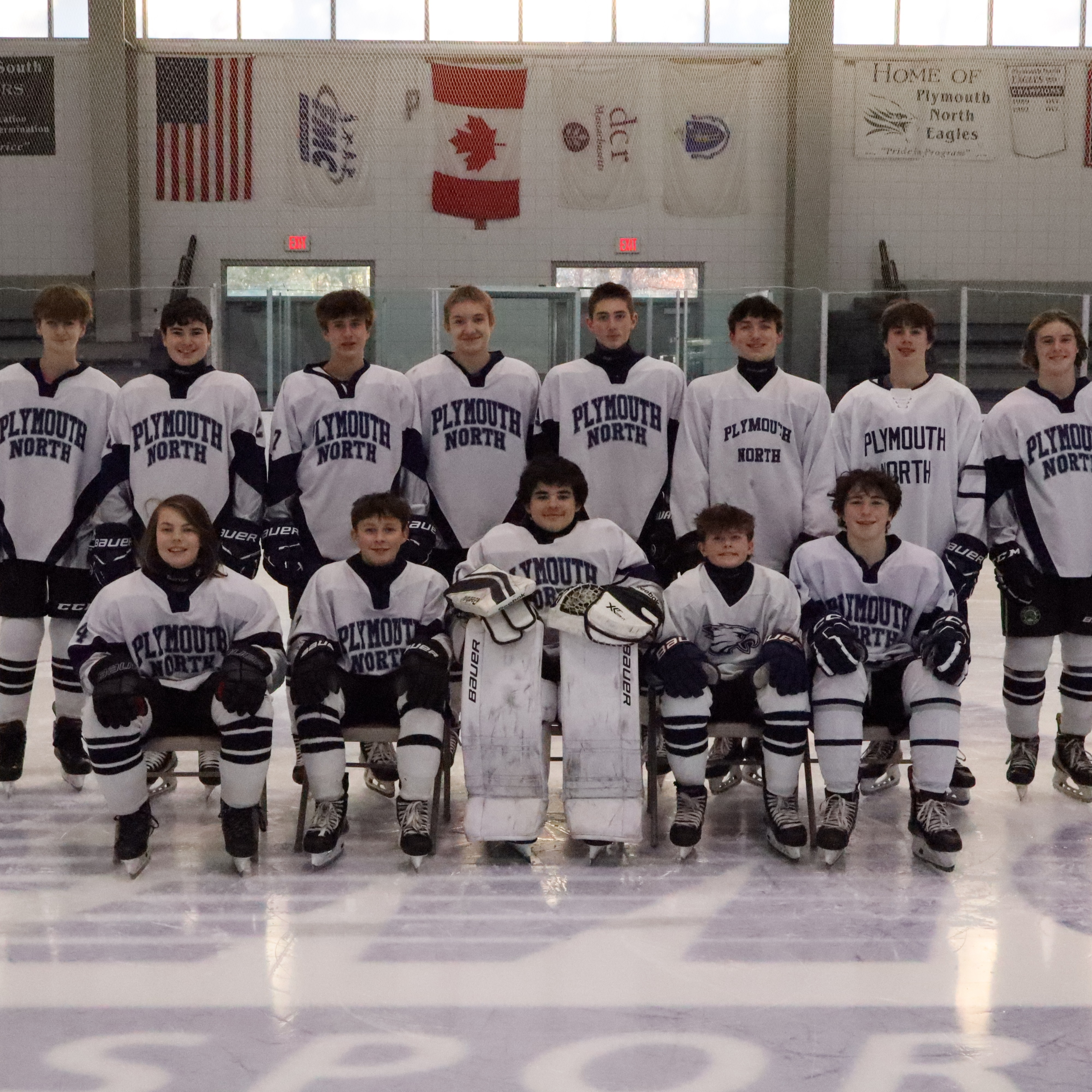 Plymouth North hockey players on the ice.