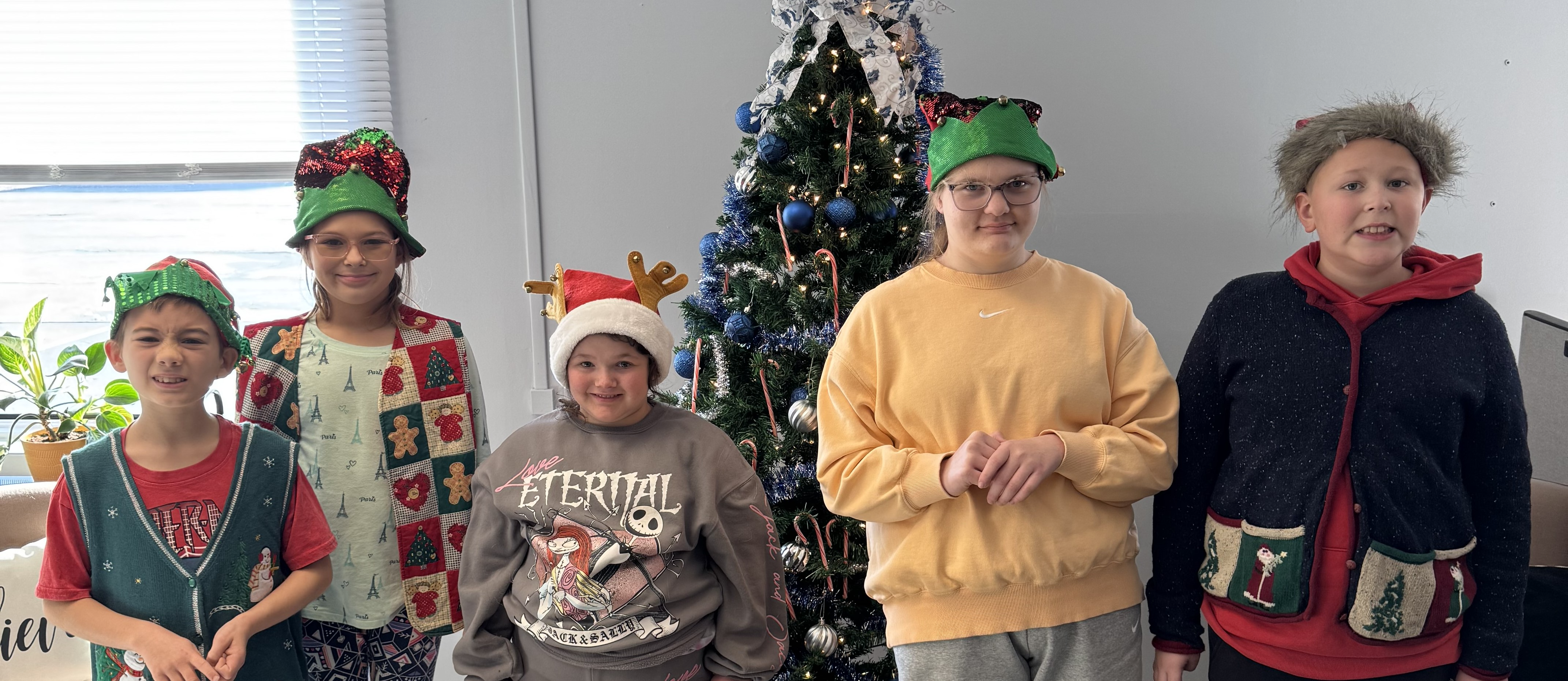 Mrs. Kull's Lifeskills class decorating the Christmas tree at the District Office