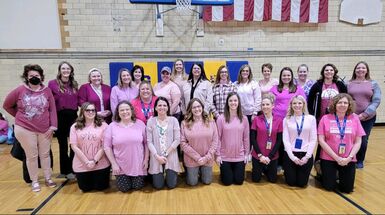 teachers in pink and white posing in a photo