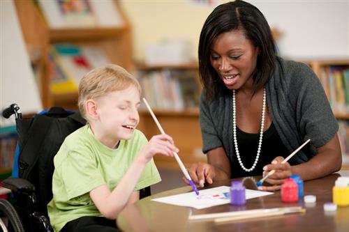Special Education teacher assisting a student