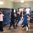 students and teacher dancing