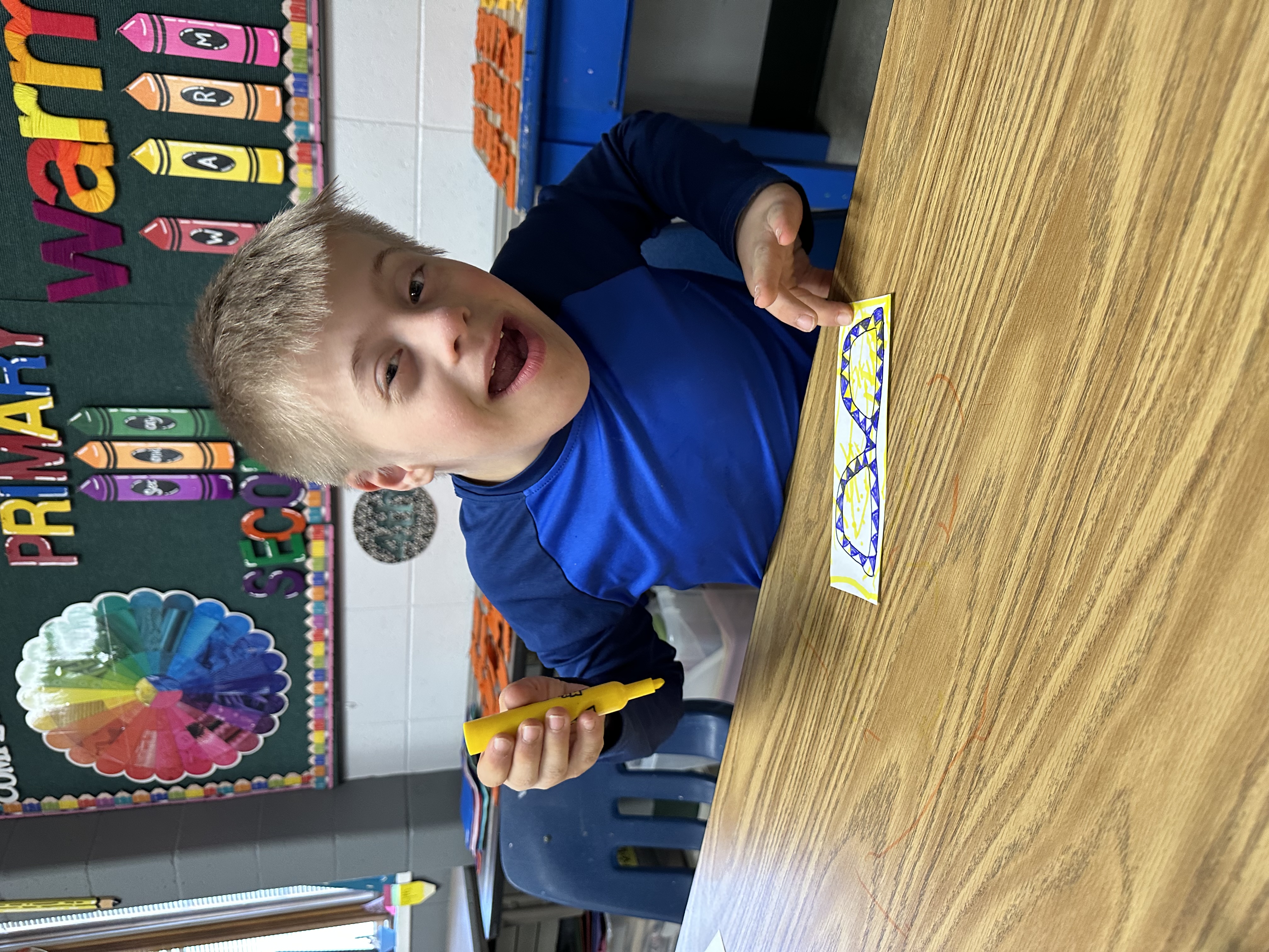 A student smiling while working