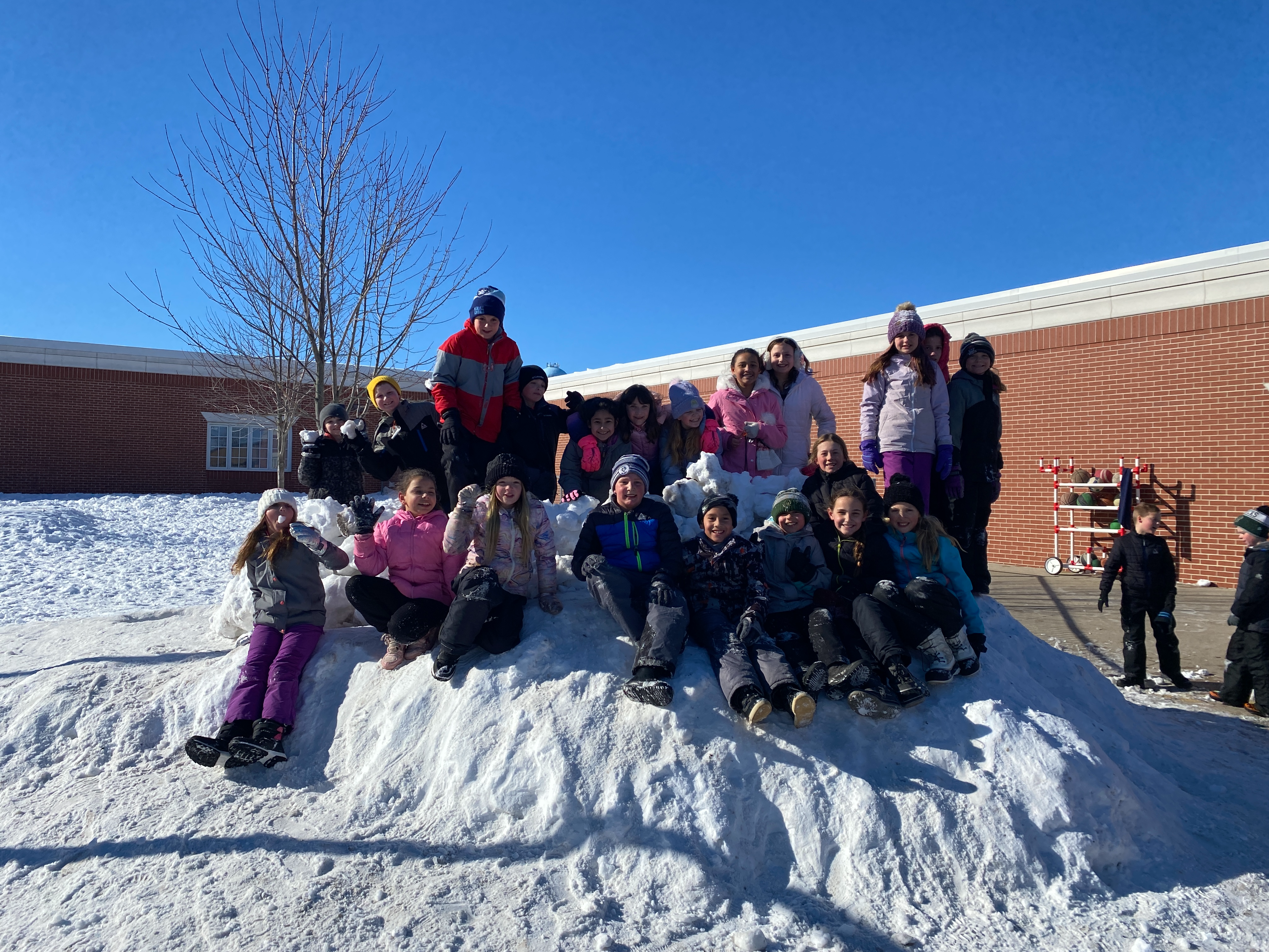 4th grade students enjoying the new snow hill on the playground