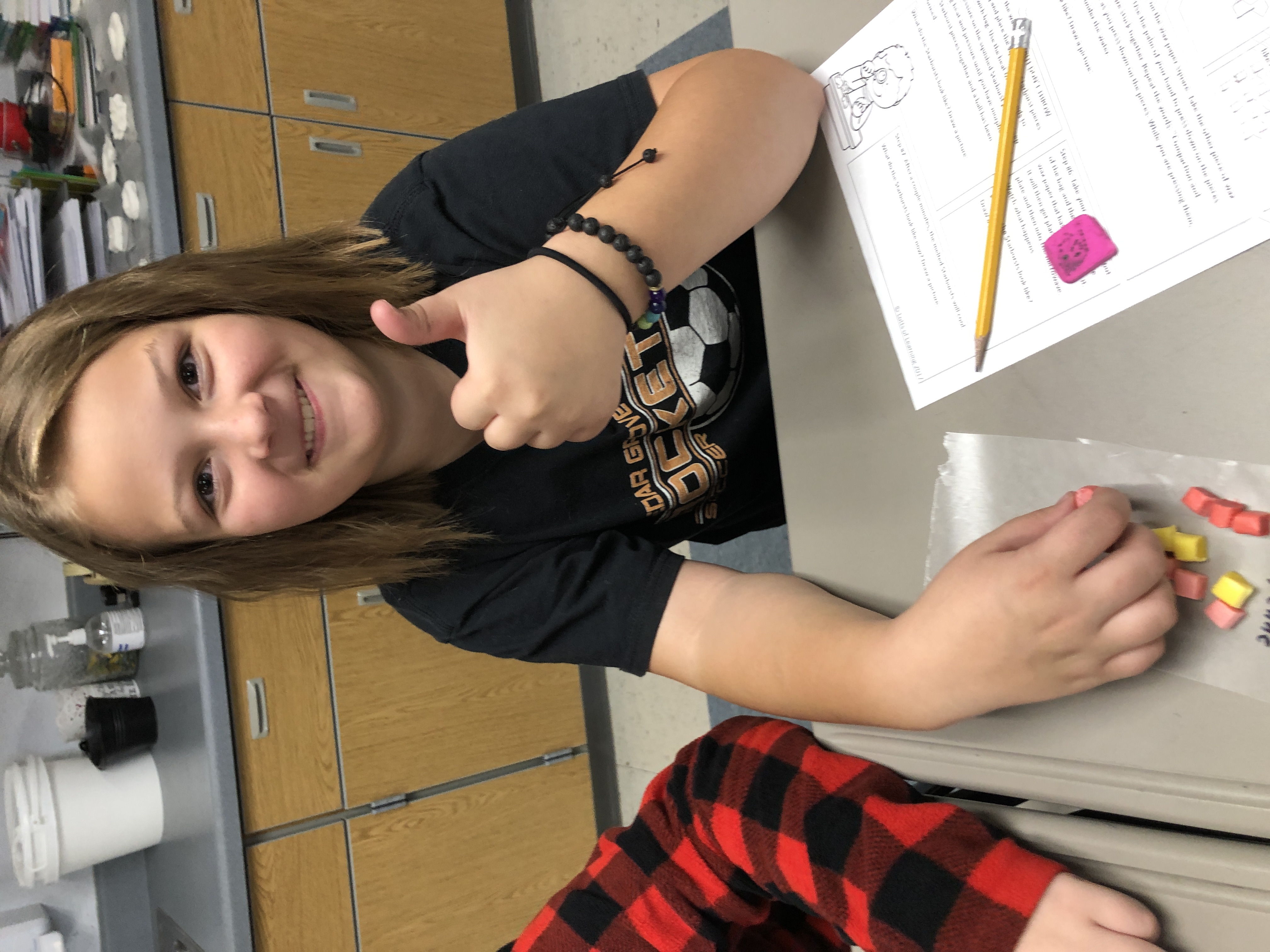 A smiling student giving a thumb's up