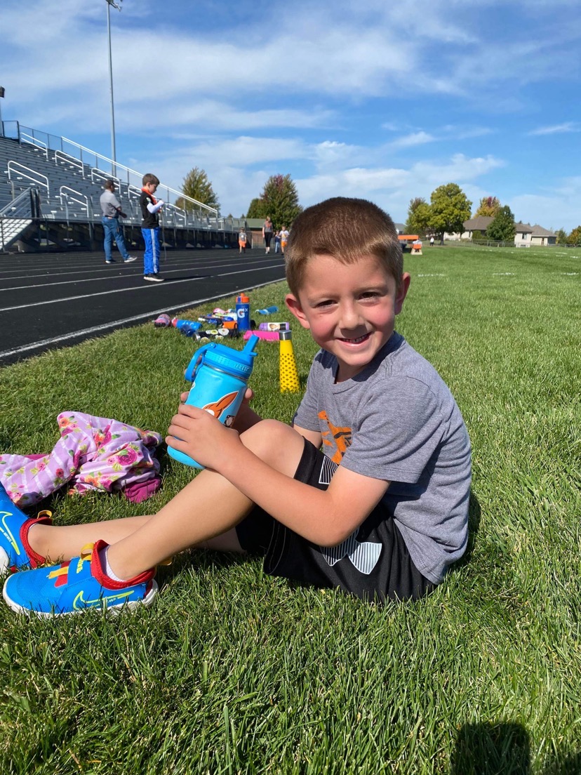 A student enjoying the summer sun on the grass