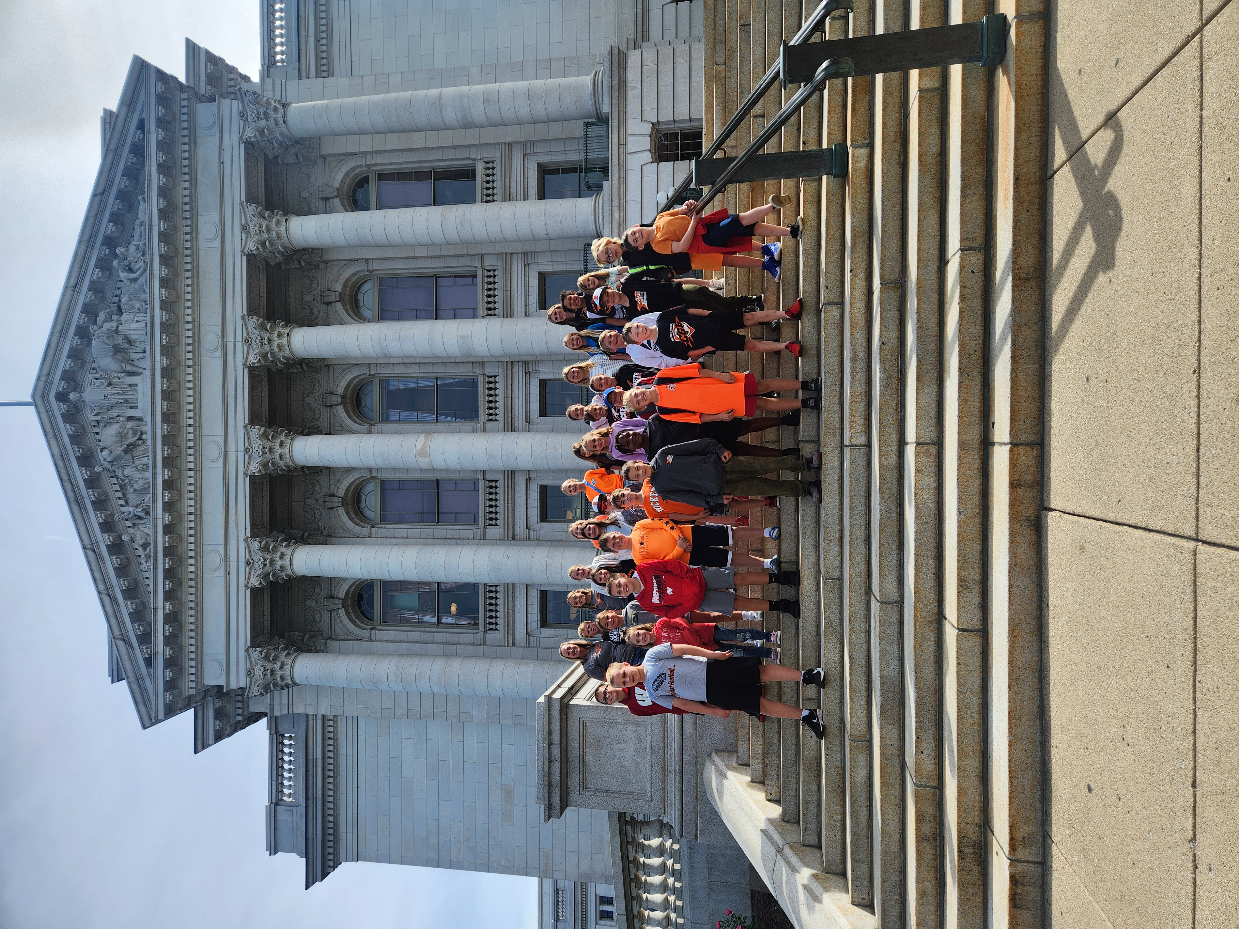 Students standing on the Capitol Steps during a trip to Madison