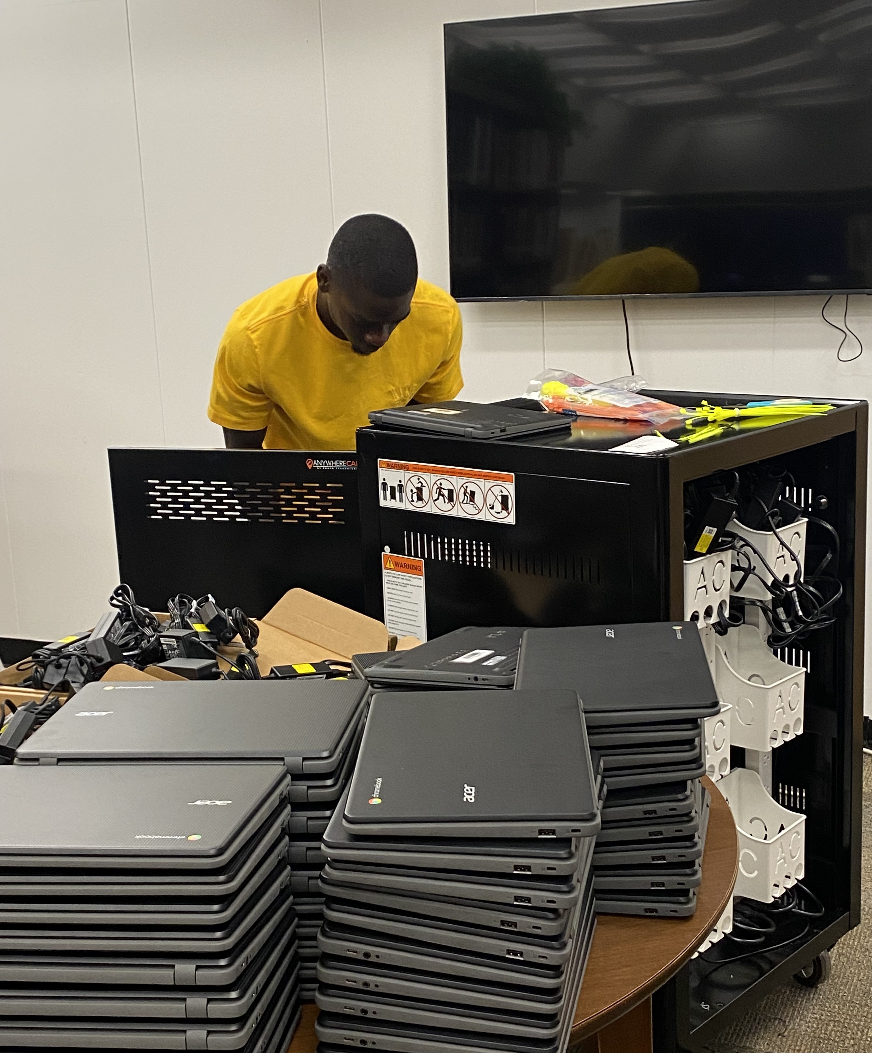 Student wiring a Chromebook Cart