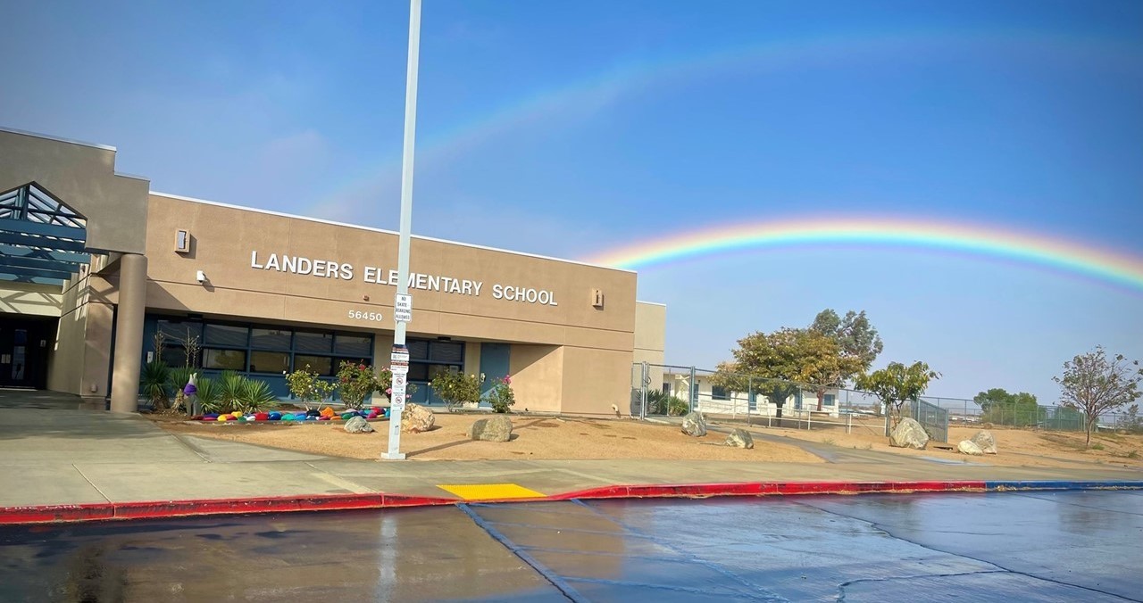 an exterior shot of Landers Elementary with a rainbow shining overhead