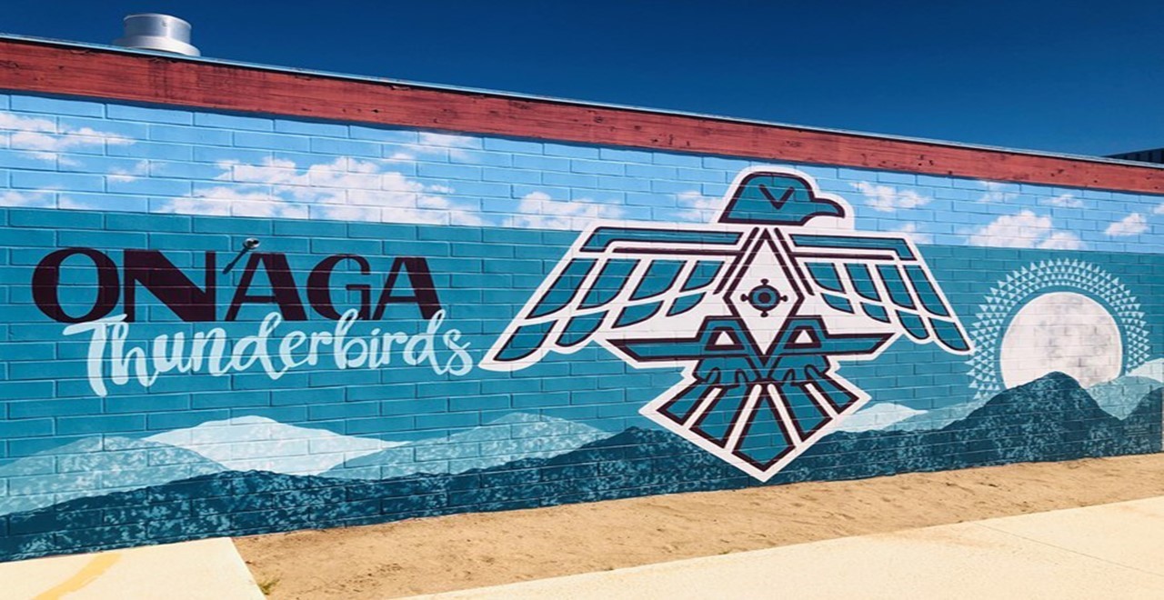a mural of a thunderbird in teal with the caption "Onaga Thunderbirds"