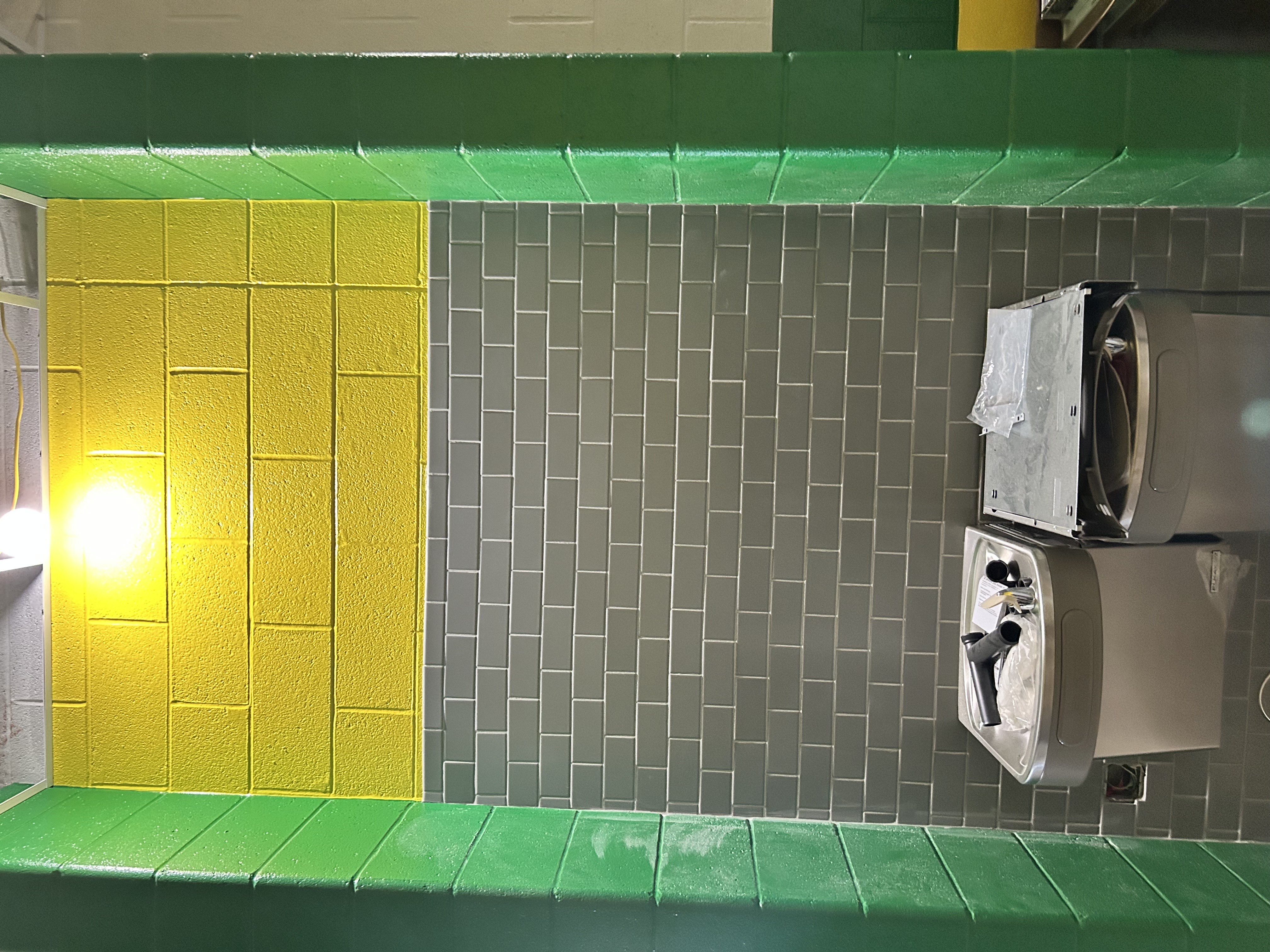 subway tile around water fountain