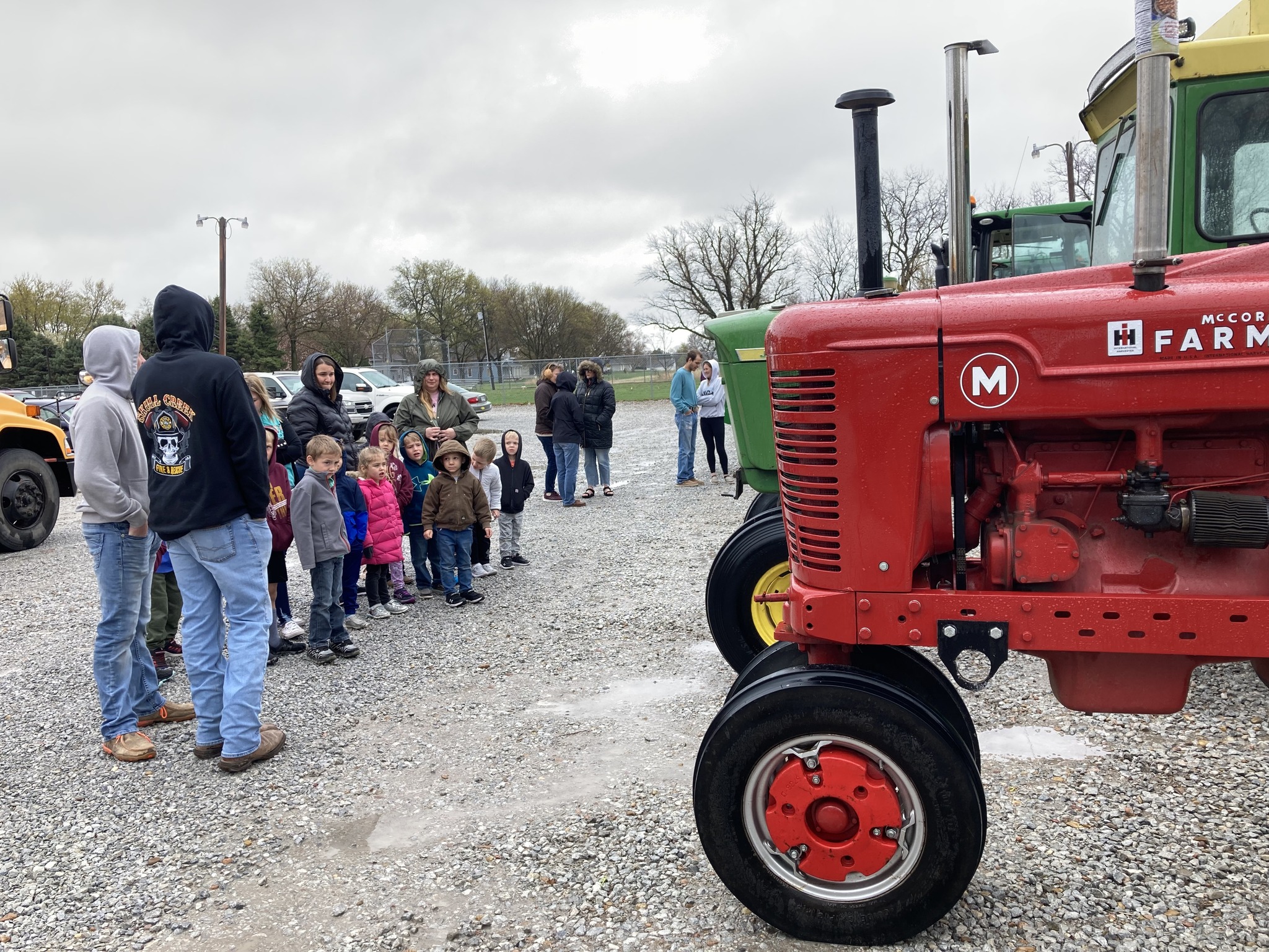 kids looking at tractors and learning