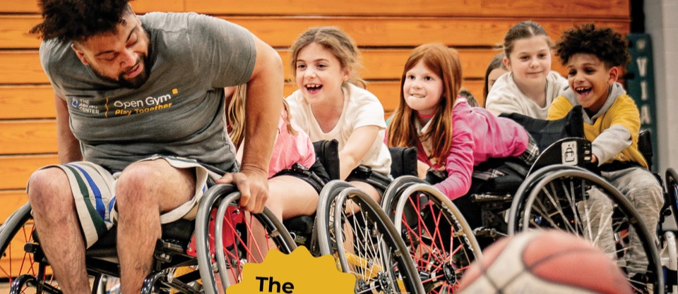 Ability Center leader leading children in wheelchair basketball
