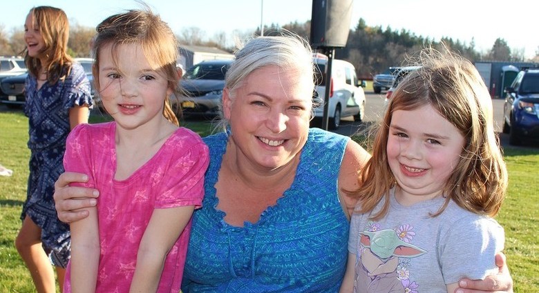 Woman and two kids smiling to camera