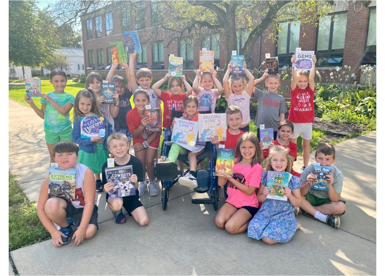 Students Reading Books Outside Enjoying the Weather