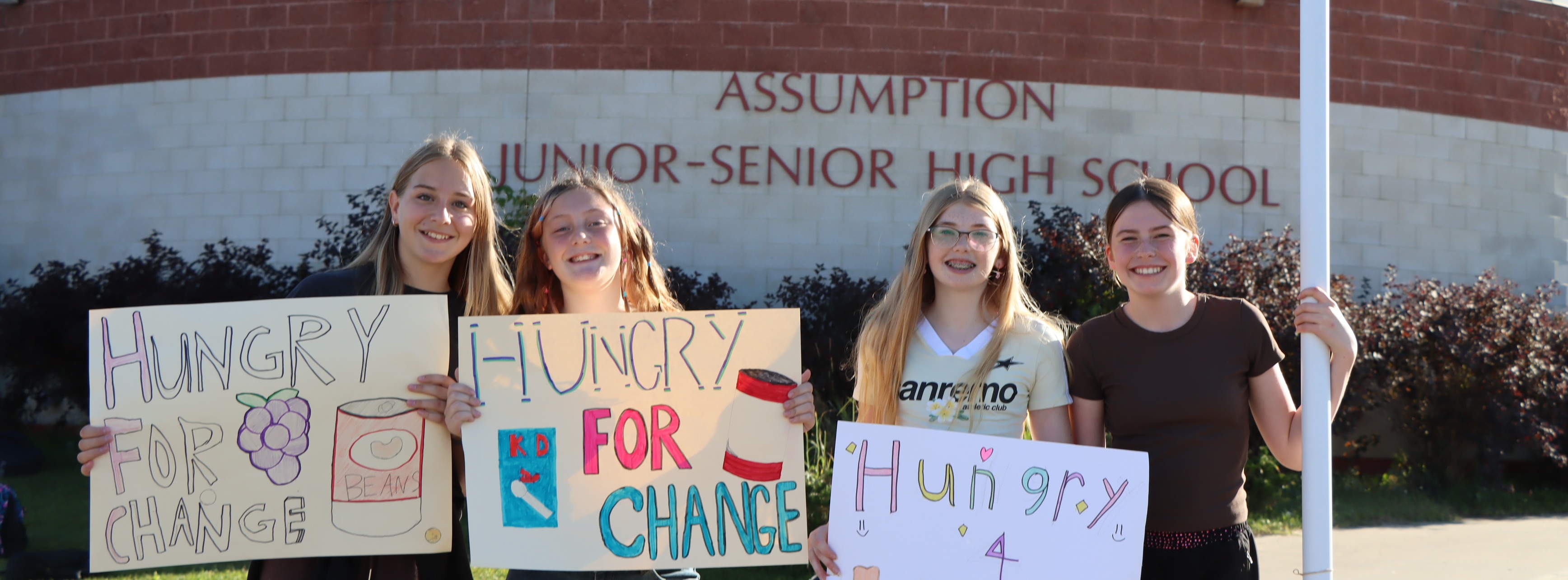 Assumption.- students holding signs