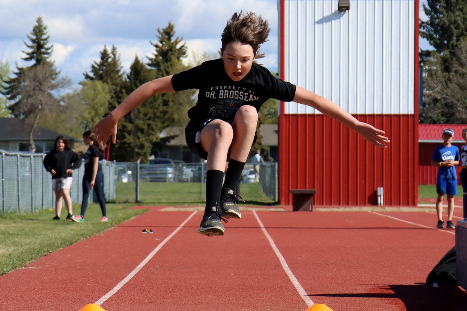 Boy jumping at track and field
