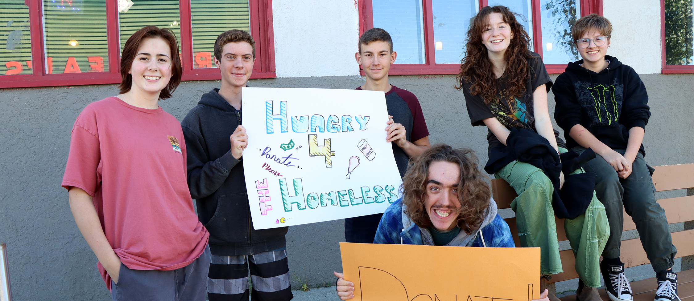 Students holding signs for fundraiser