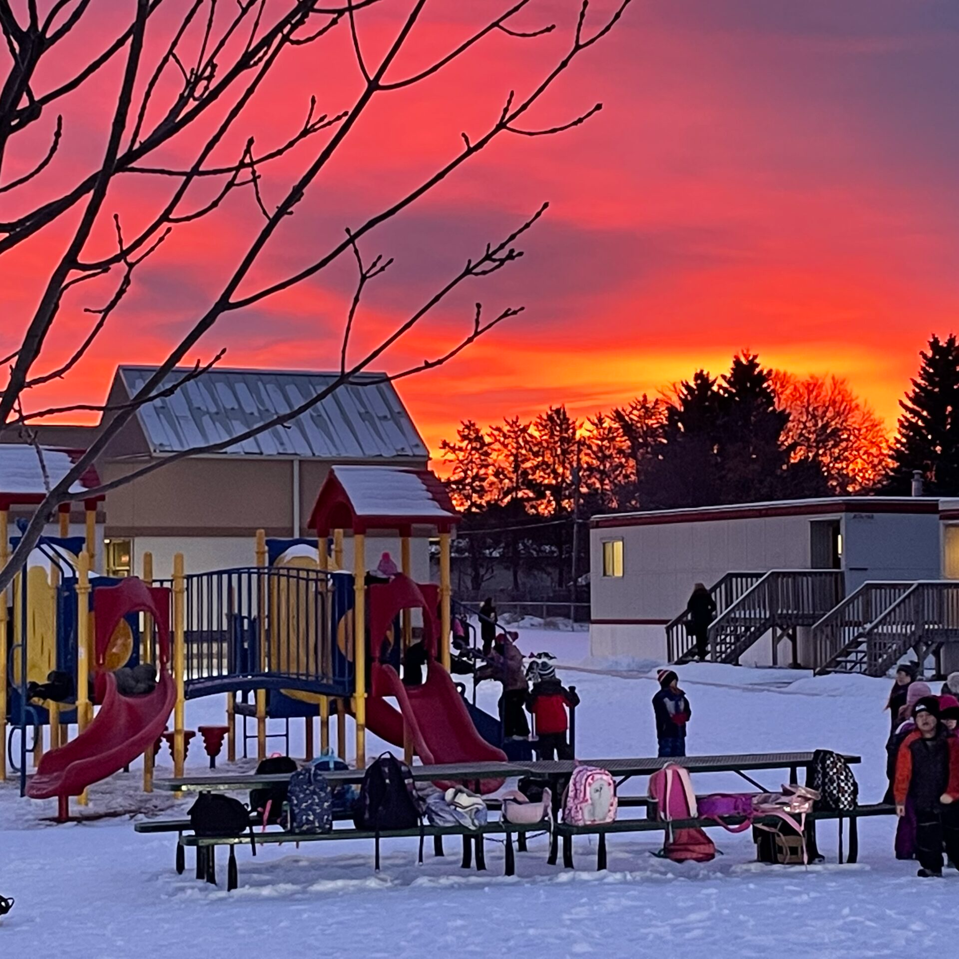 kids in playground with sunset in background