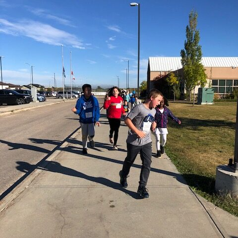 students running on sidewalk