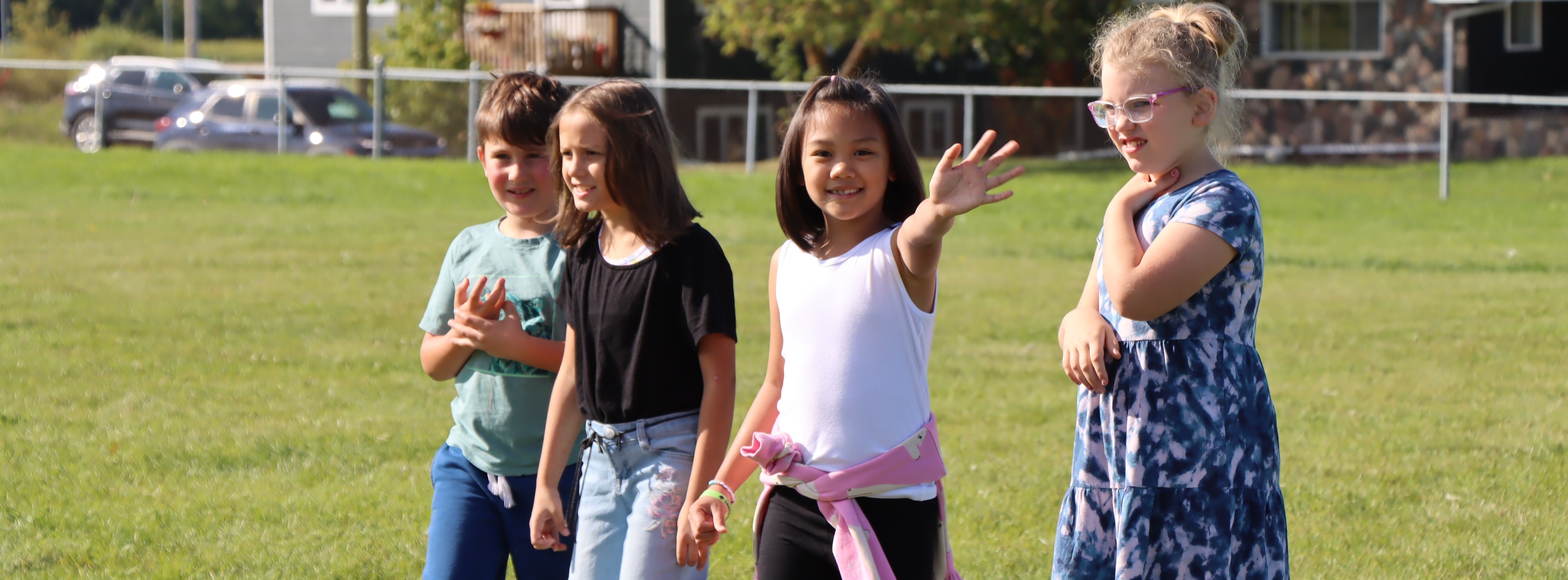 students waving at tjhe park
