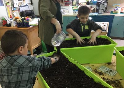 students digging in dirt