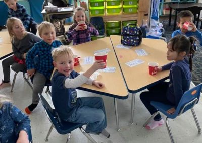 students sitting at desks during snack time