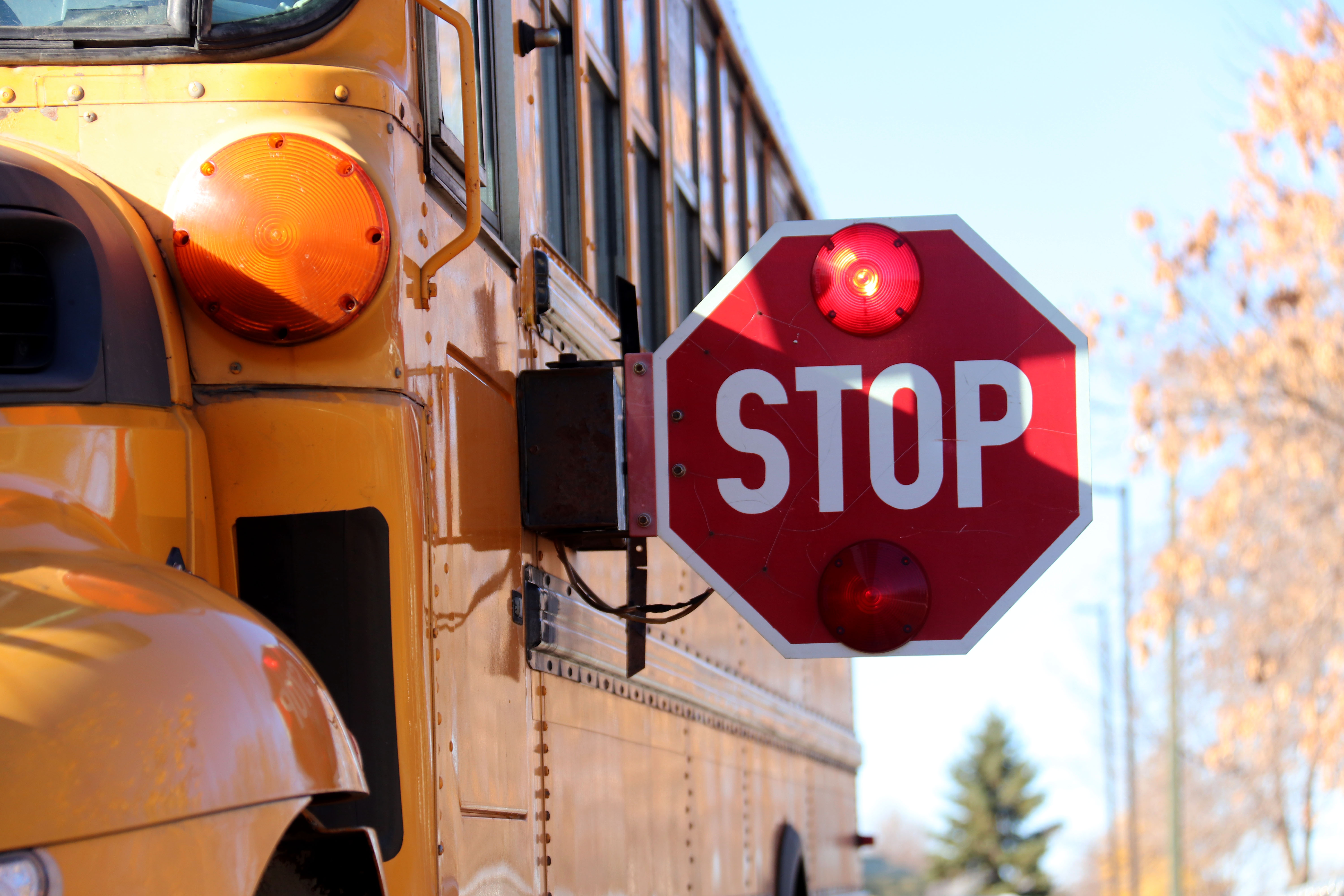 School bus stop sign flashing red lights