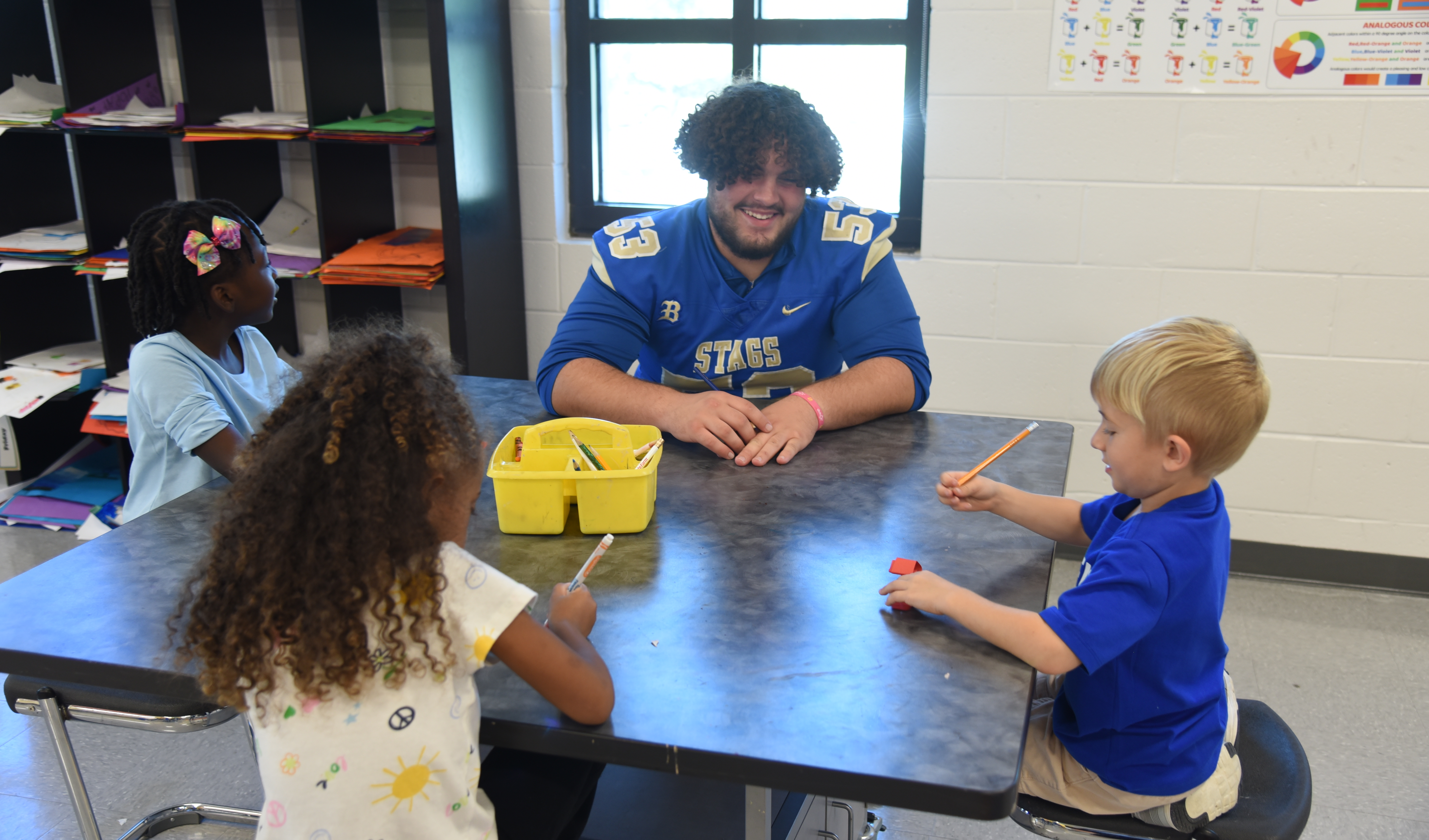 BHS football player with FBE students