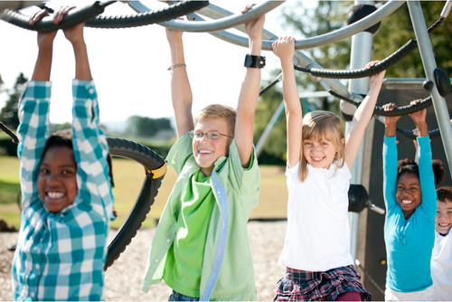 three children hanging from the monkey bar