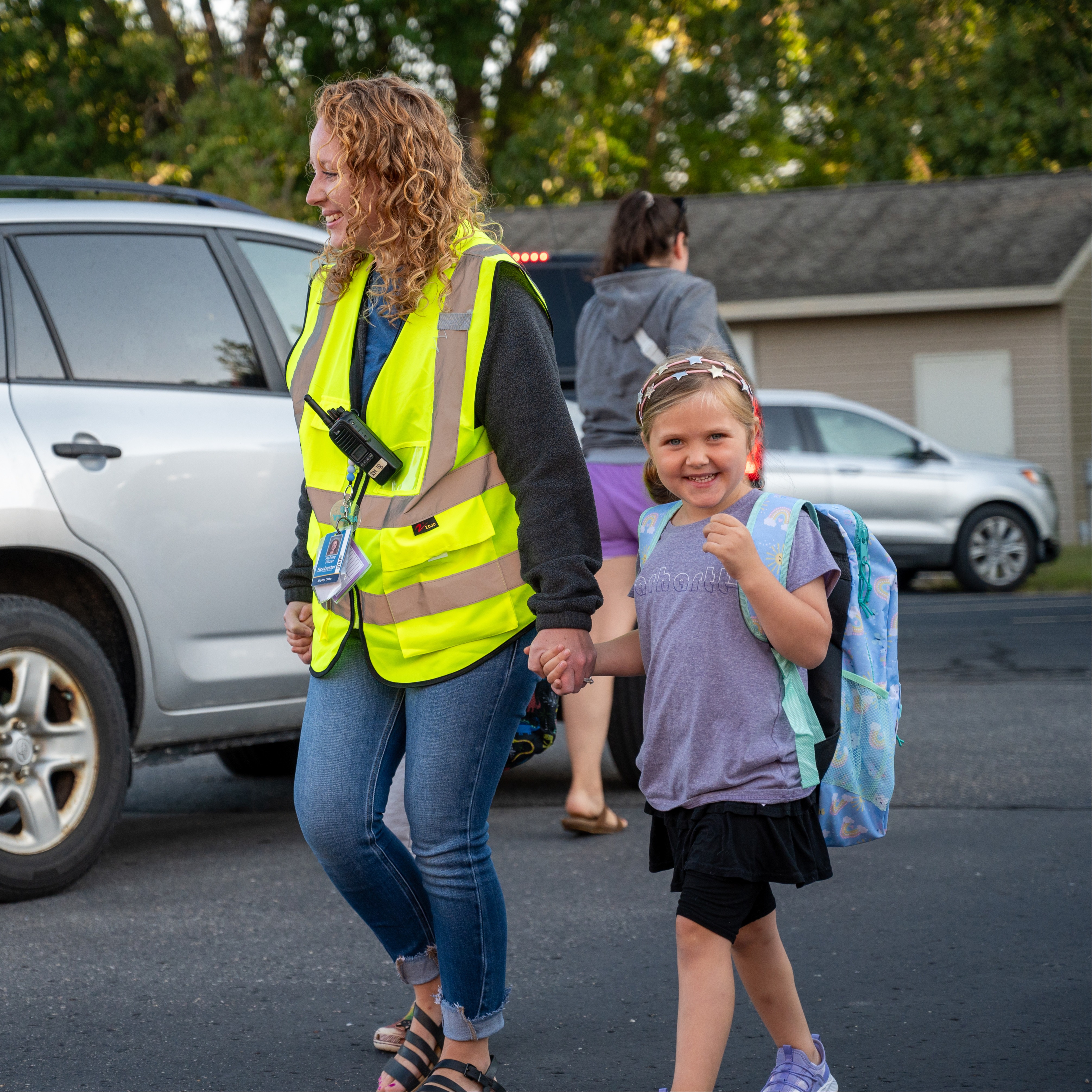 Preschool teacher walking student to class