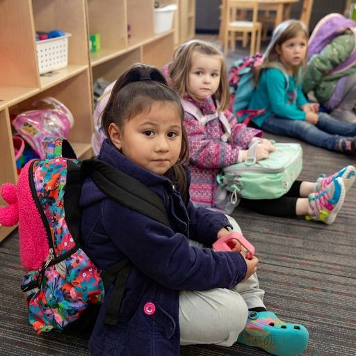 Preschool students packed up and read to go home for the day.