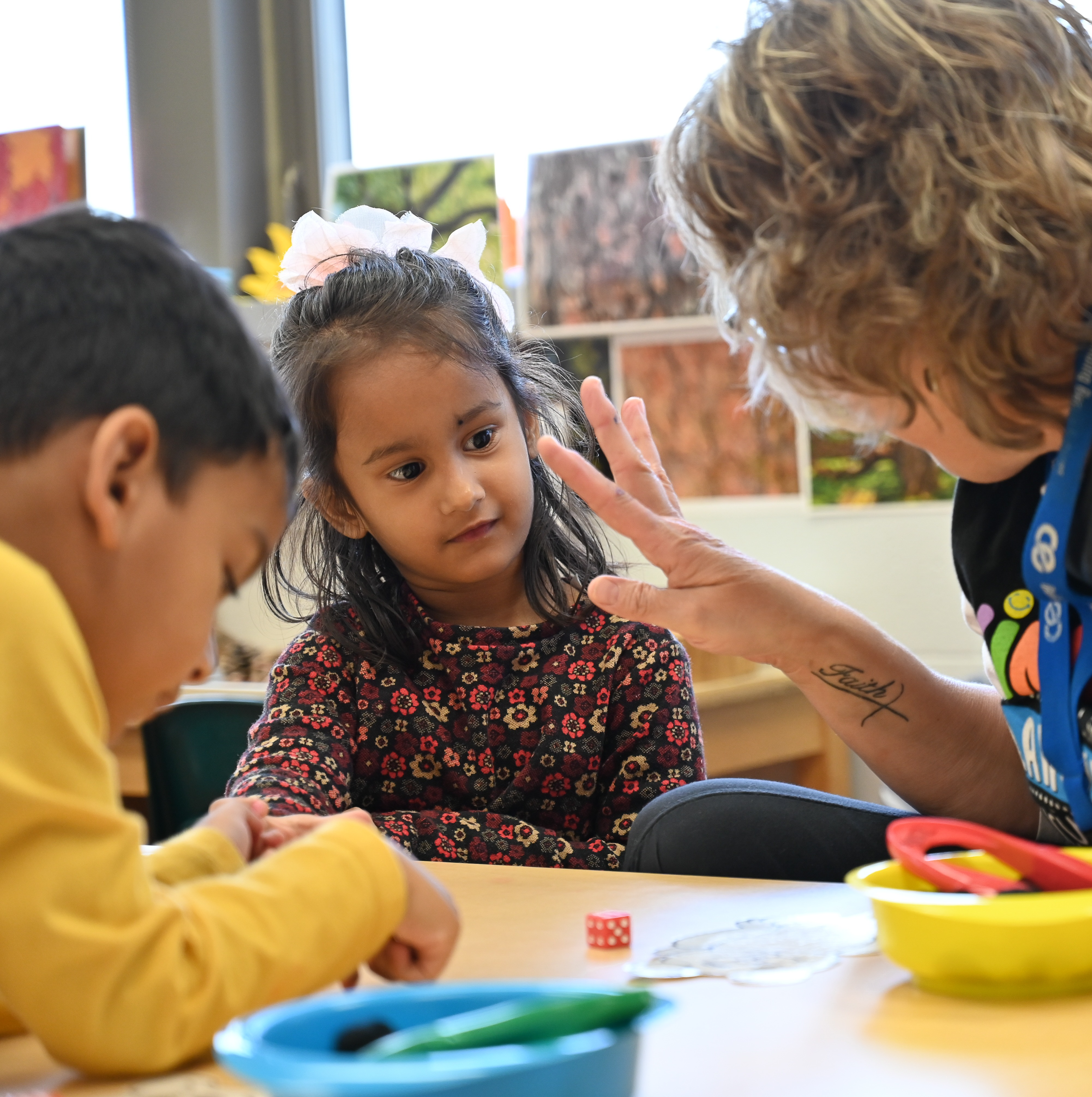 Students working on numbers with the teacher.