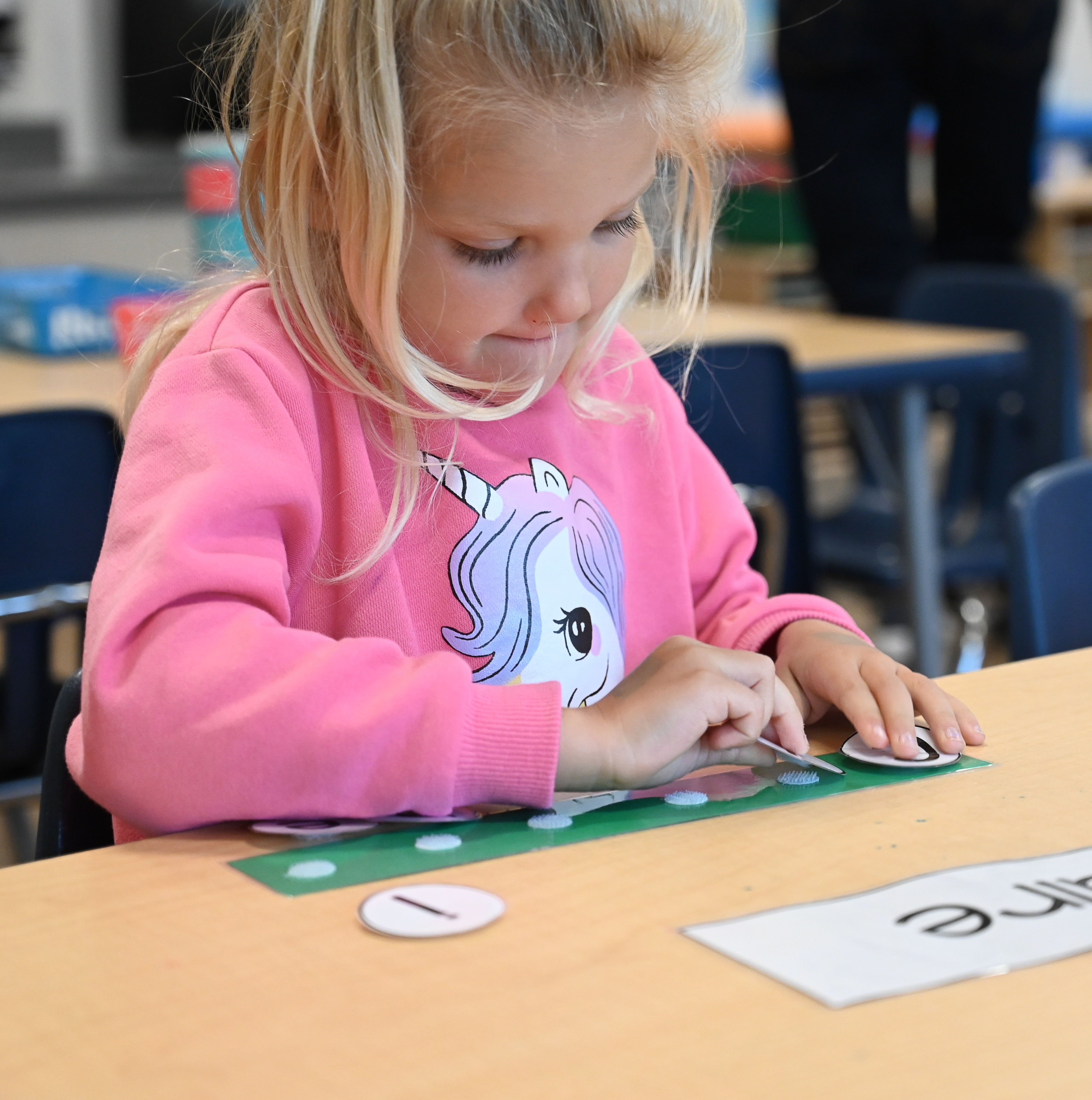 Student working on spelling the letters in her name