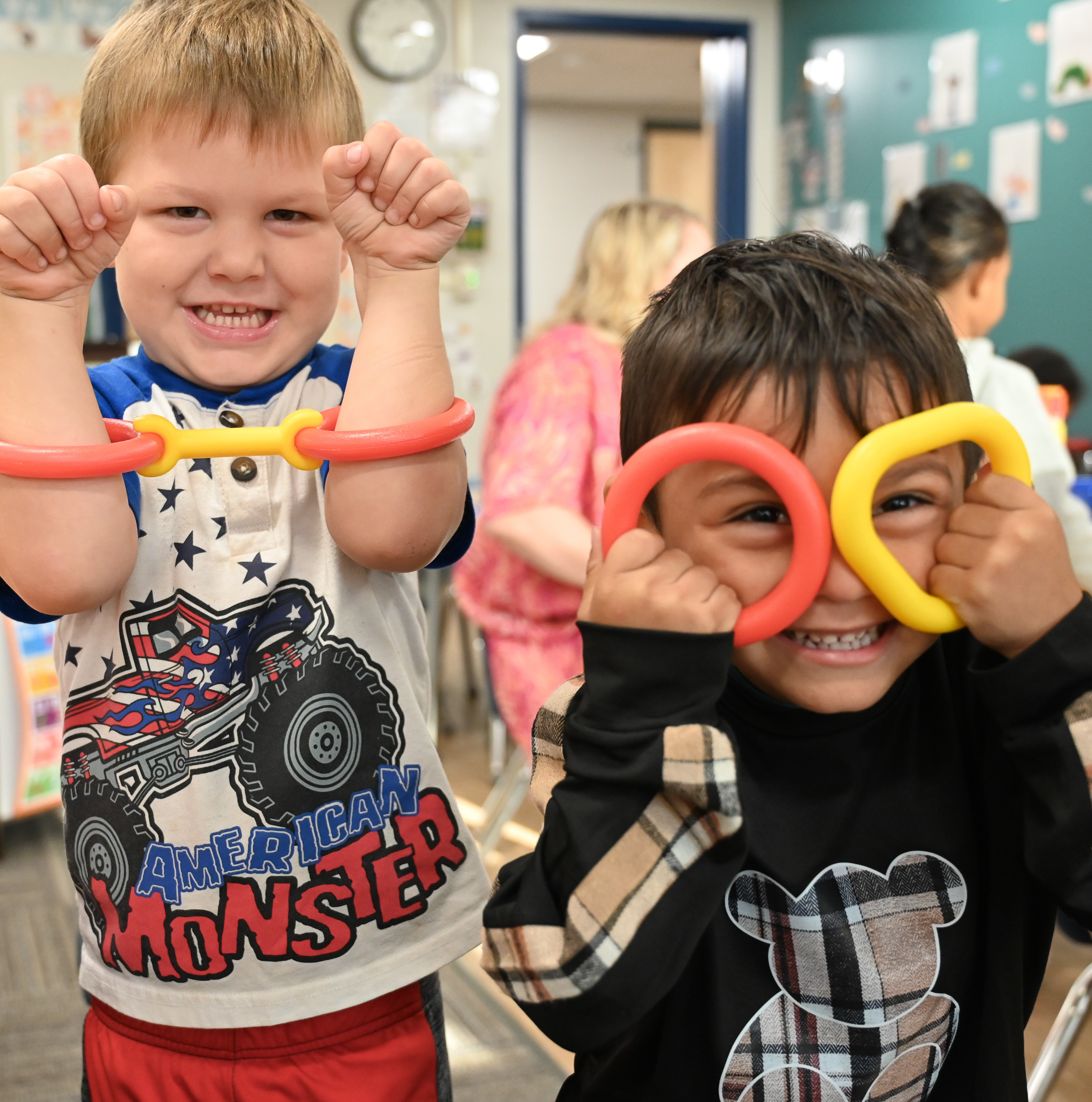 Two preschool students playing with create buildiers