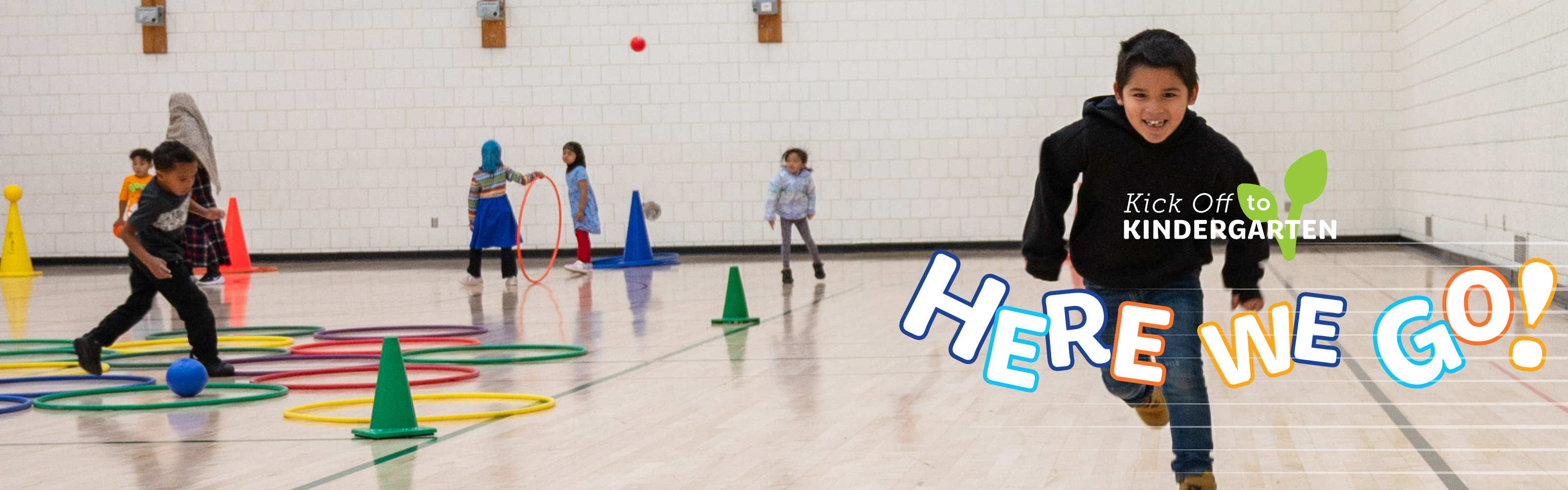 Student running at the camera in the gym with text overlay "Here we go!"
