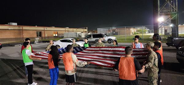 students folding a flag