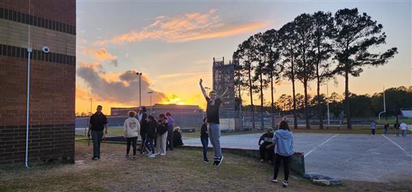 student leaping into the air