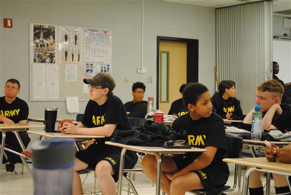 students wearing "army" shirts sitting in a classroom