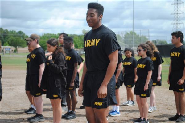 students outdoors in rows wearing matching Army shirts