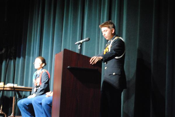 speaker standing behind a podium