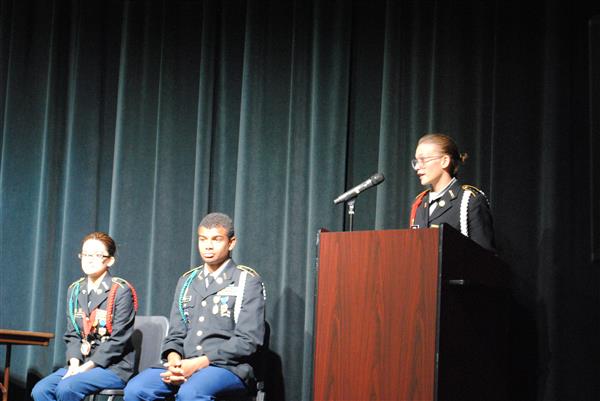 speaker standing behind a podium