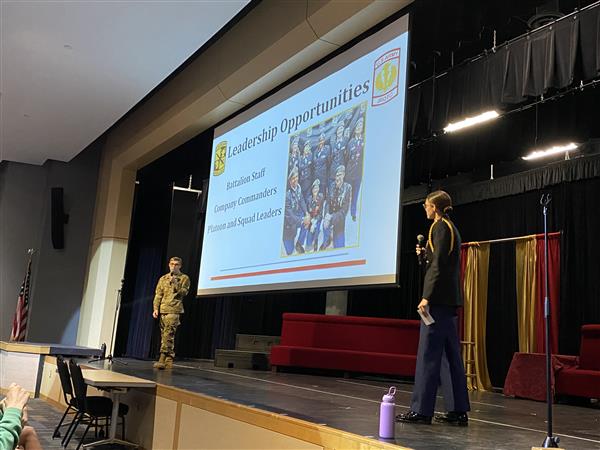 students presenting on stage