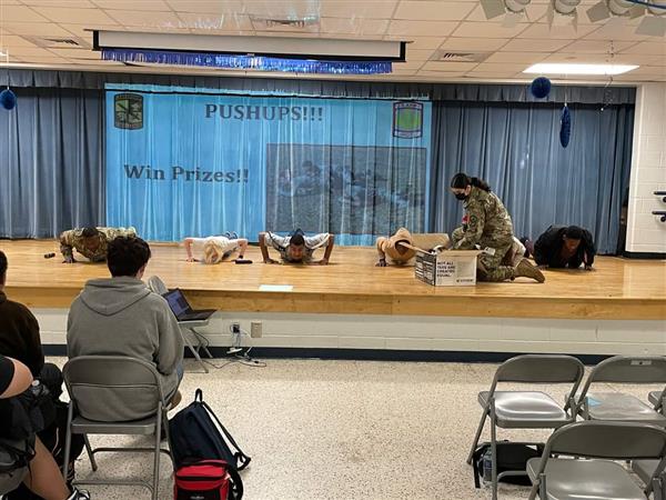 students doing pushups on stage