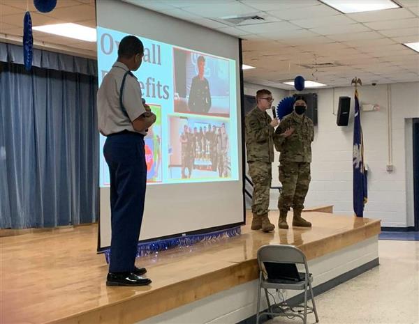 students giving a presentation on stage