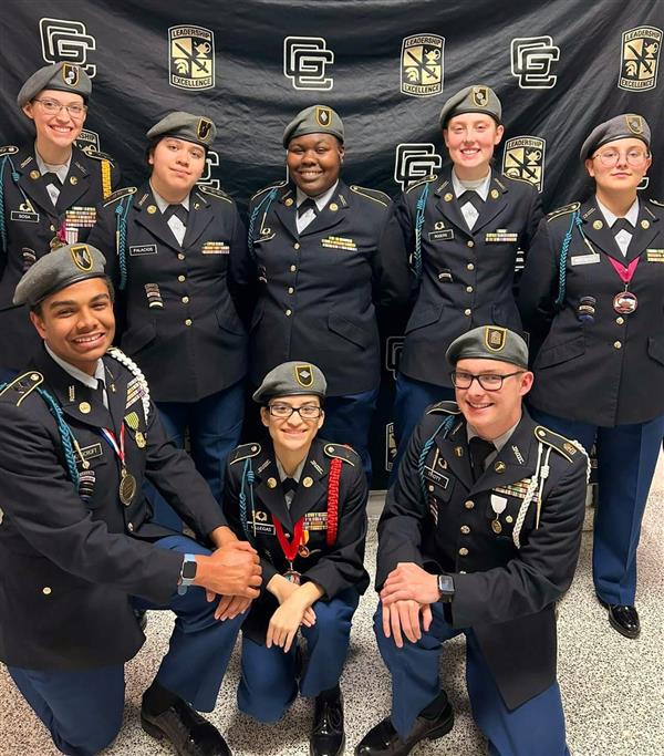 eight JROTC students smile for the camera