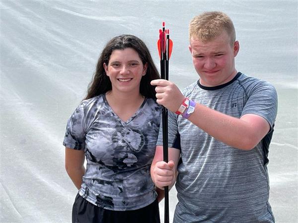 two students hold arrows