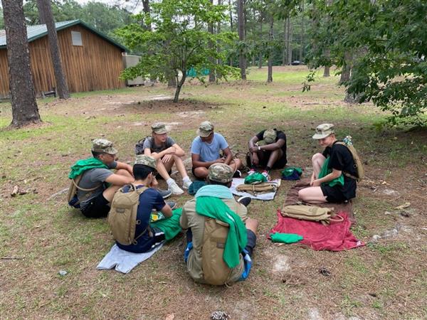 a group of students sitting in a circle outside