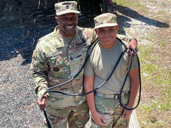 instructor poses with a student